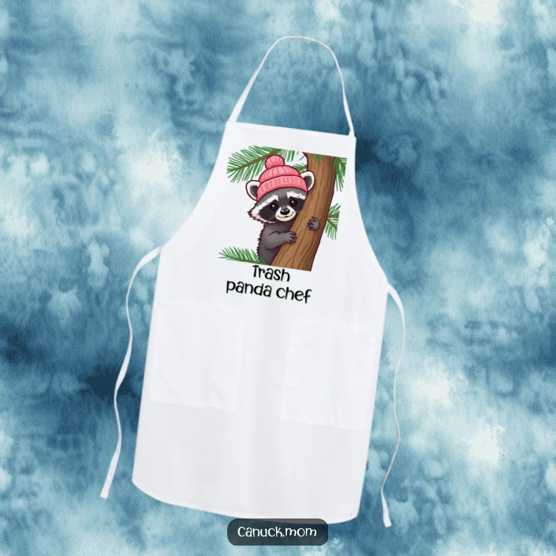 Funny Raccoon Hat Apron: A curious raccoon wearing a tiny knitted hat peeks from behind a pine tree, ideal for kitchen fun.