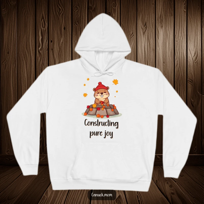 Funny beaver in a red toque constructing a dam with maple leaves on a cozy hoodie.