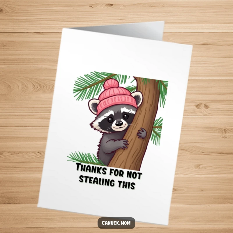 Funny Free Printable Thank You Card: A curious racoon in a knitted hat peeks from behind a pine tree, conveying thanks.