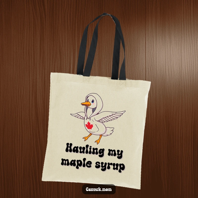 Funny goose wearing a Canadiana hoodie, flying north, a humorous tote bag for travelers and bird lovers.